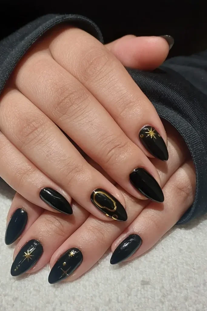 Black Christmas Nails With Gold Stars and a Chrome Outline