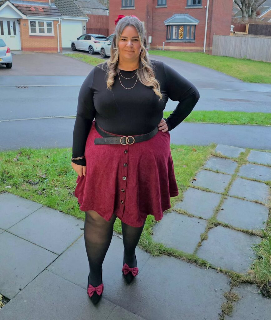 Black Top With a Burgundy Skater Skirt and Bow Shoes